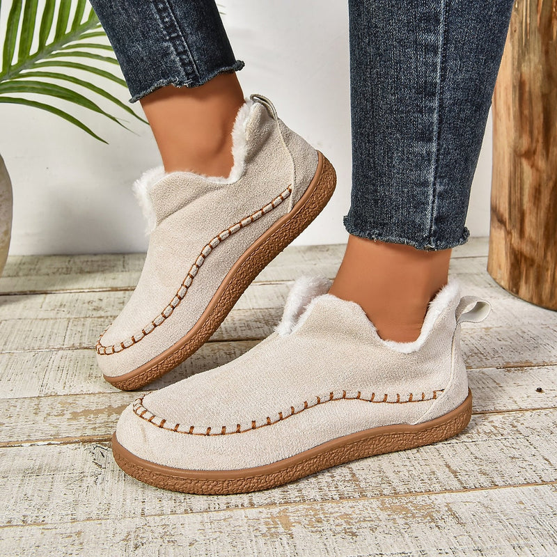 Black fur-lined slip-on ankle boots for women with sleek ankle-height silhouette