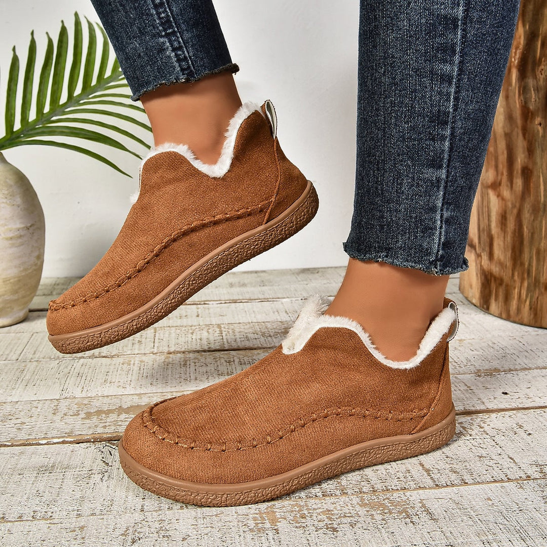 Interior plush fur lining detail of women's warm slip-on ankle boots