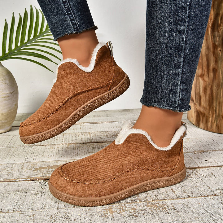 Interior plush fur lining detail of women's warm slip-on ankle boots