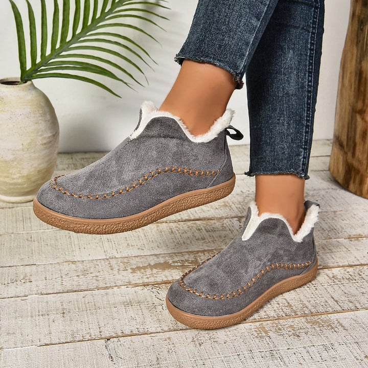 Side profile of brown women's slip-on ankle boots highlighting thick sole