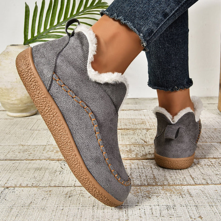 Close-up of slip-on opening showing soft plush fur lining interior