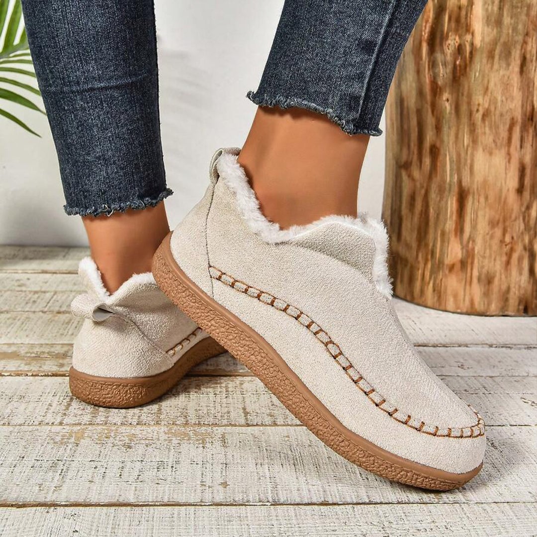 Detail shot of textured anti-slip outsole on women's fur-lined slip-on ankle boots