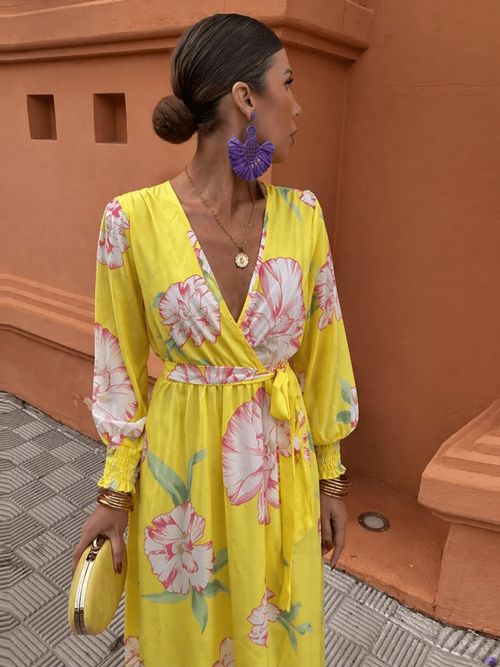 Woman wearing a yellow floral lace dress with a figure-flattering silhouette, styled for a summer wedding