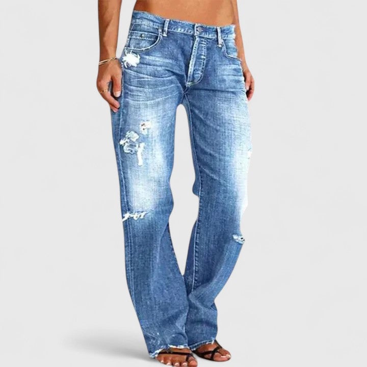 Front view of Sadie low-rise distressed straight leg jeans in light blue wash with rip detailing