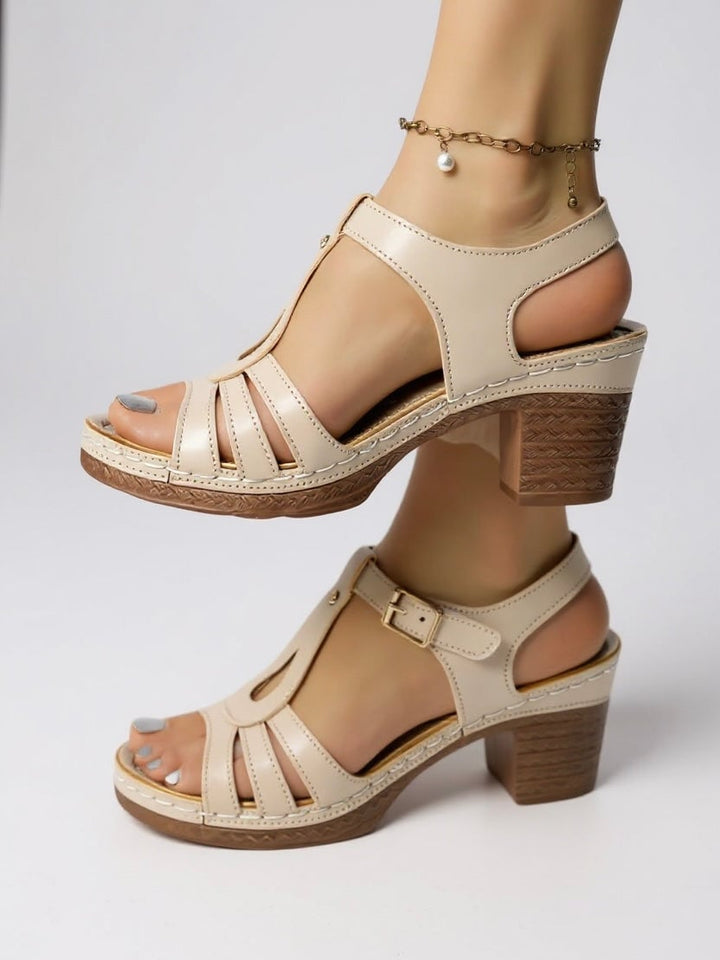 Saffron sandal in White colorway, styled on foot with tailored wide-leg trousers