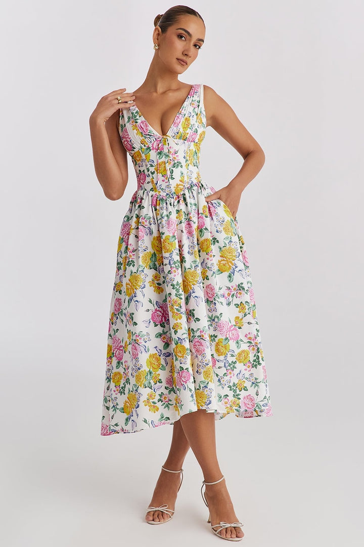 Woman wearing the Saffron yellow floral summer dress with a flowing silhouette and waist-defining fit