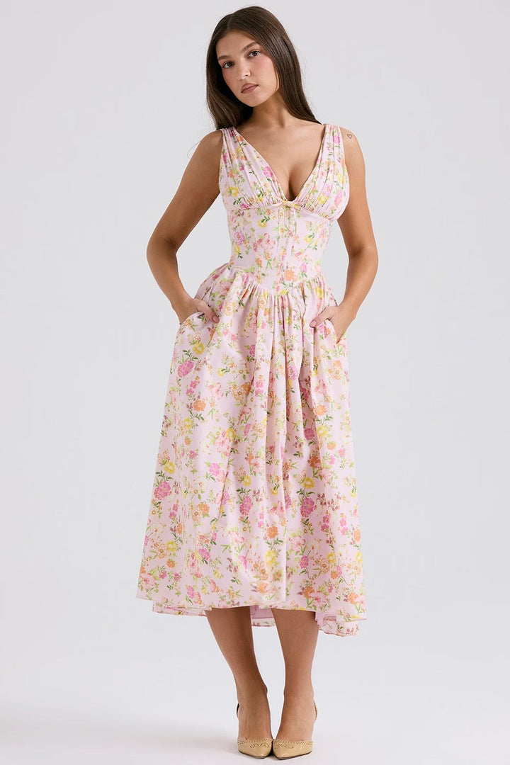Front view of the Saffron pink floral wedding guest dress showing feminine drape and elegant detailing