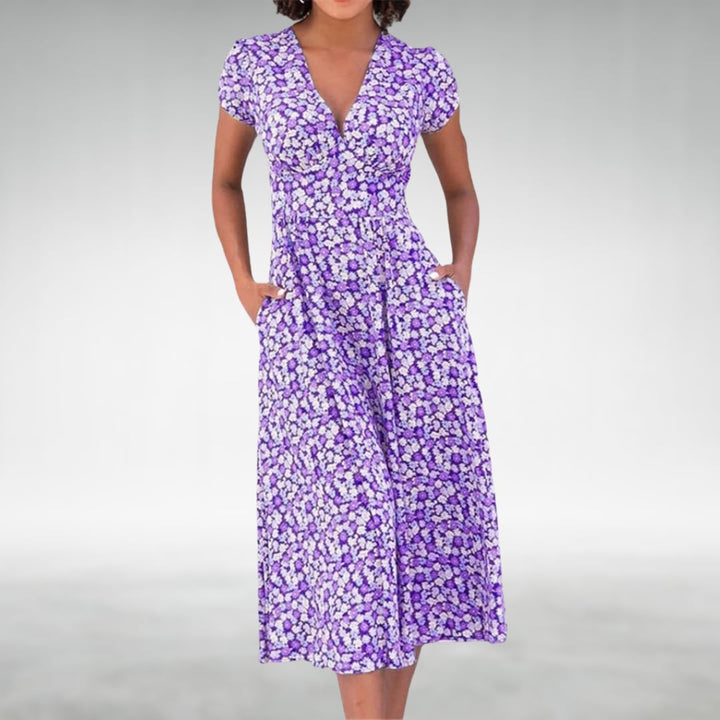 Side view of a lightweight floral midi dress in purple, showing the flowing midi-length silhouette