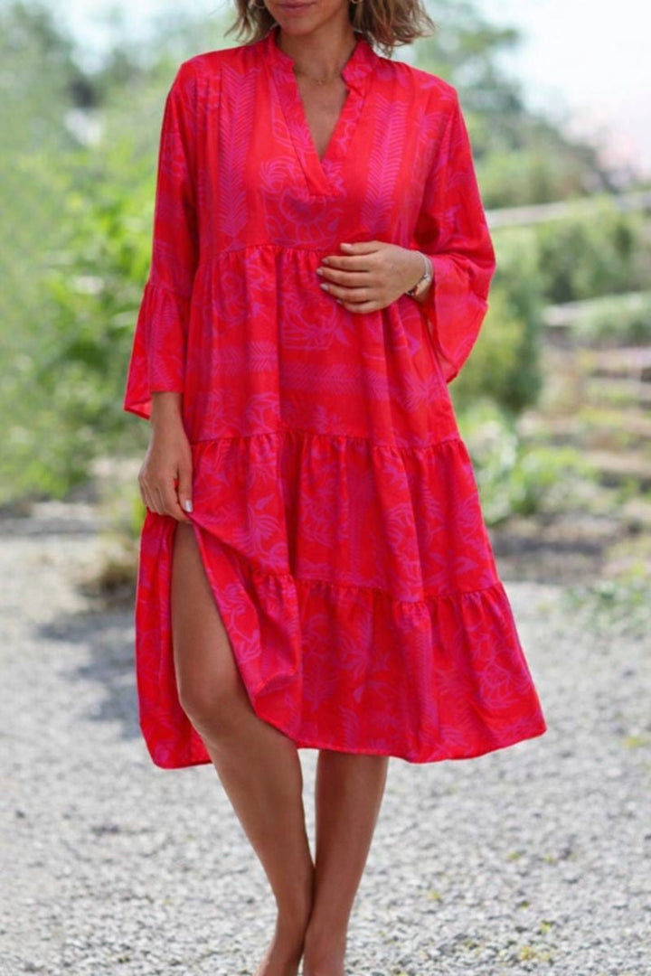 Woman wearing a red boho flowy draped dress with a relaxed loose fit, full-length front view