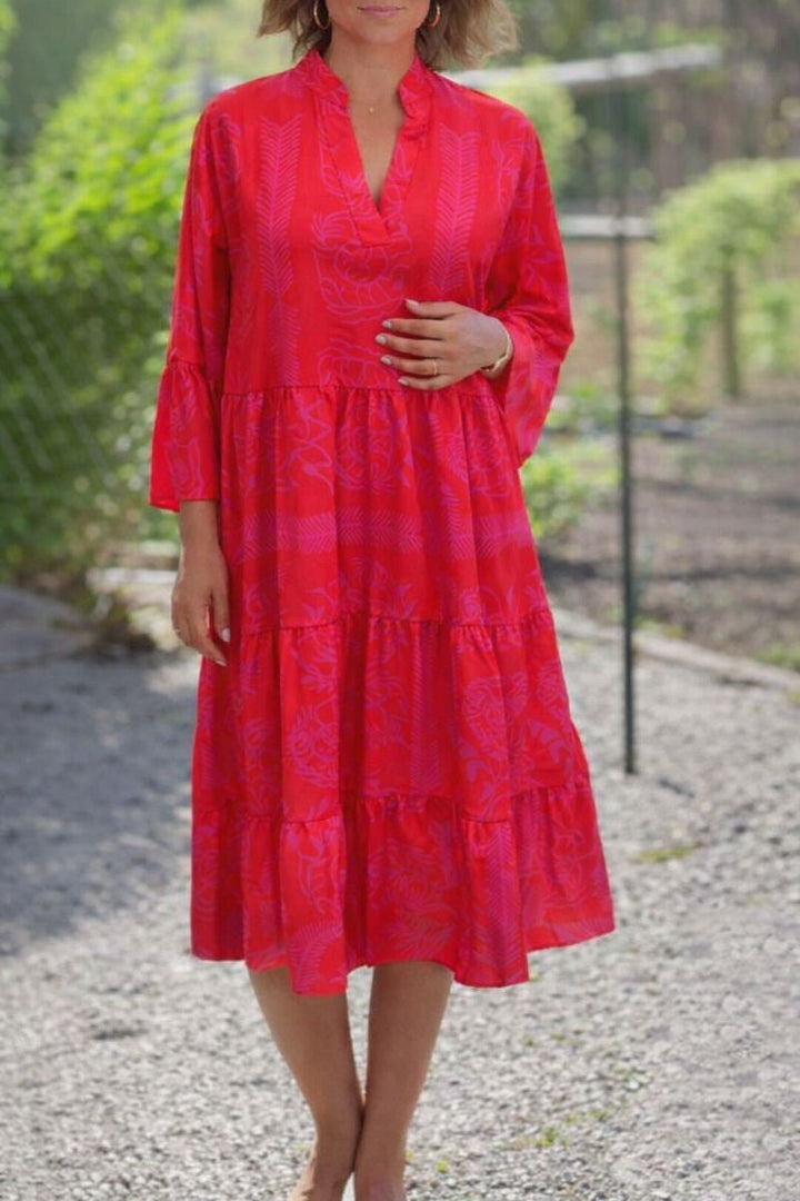 Close-up detail of the draped neckline and lightweight fabric on the red boho dress