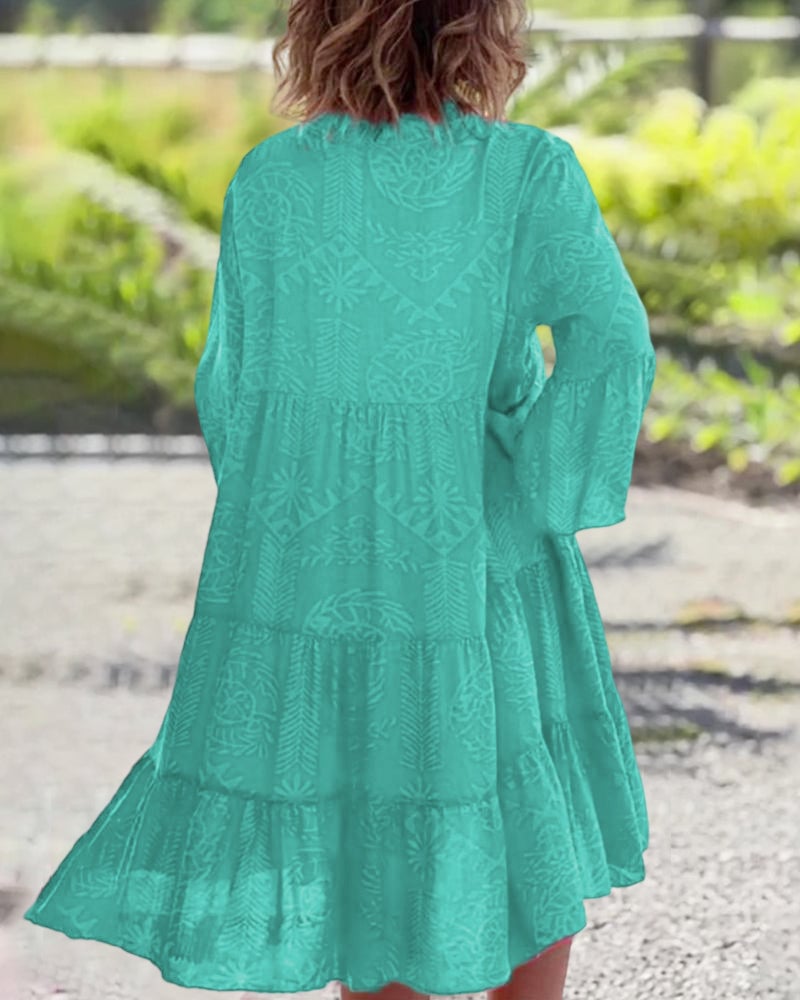 Side profile of a woman in the turquoise boho draped dress highlighting the relaxed fit and length