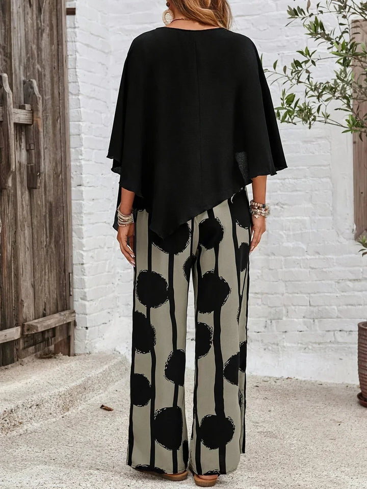 Close-up of the Sage wide-leg pants showing the graphic black-on-khaki circle and stripe print with elastic waistband