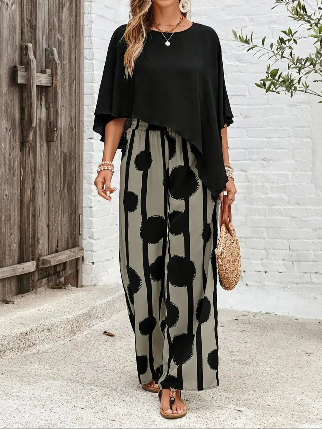 Side view of the Sage batwing top and wide-leg print pants set showing the relaxed, flowy hem and full-length pant leg