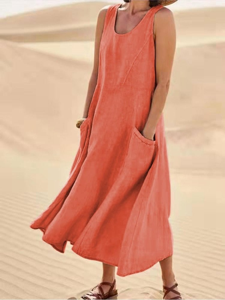 Close-up of the scoop neckline and structured armhole detail on a linen maxi dress