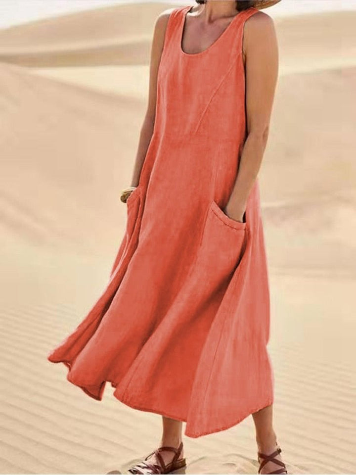 Close-up of the scoop neckline and structured armhole detail on a linen maxi dress