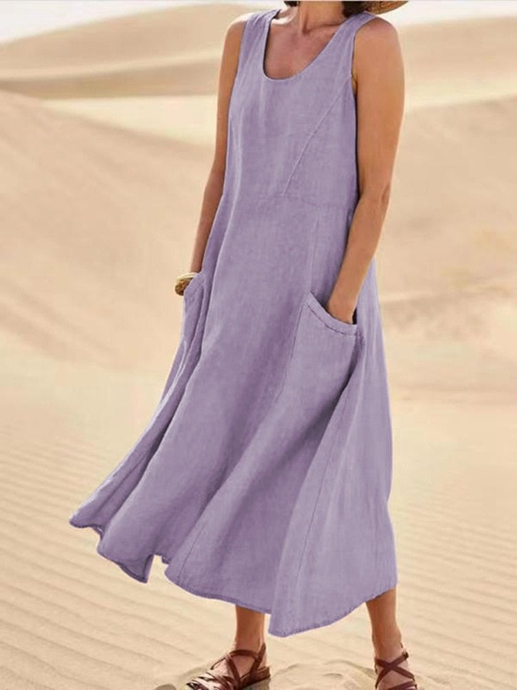 Side view of a flowing ankle-length sleeveless maxi dress in a light casual color