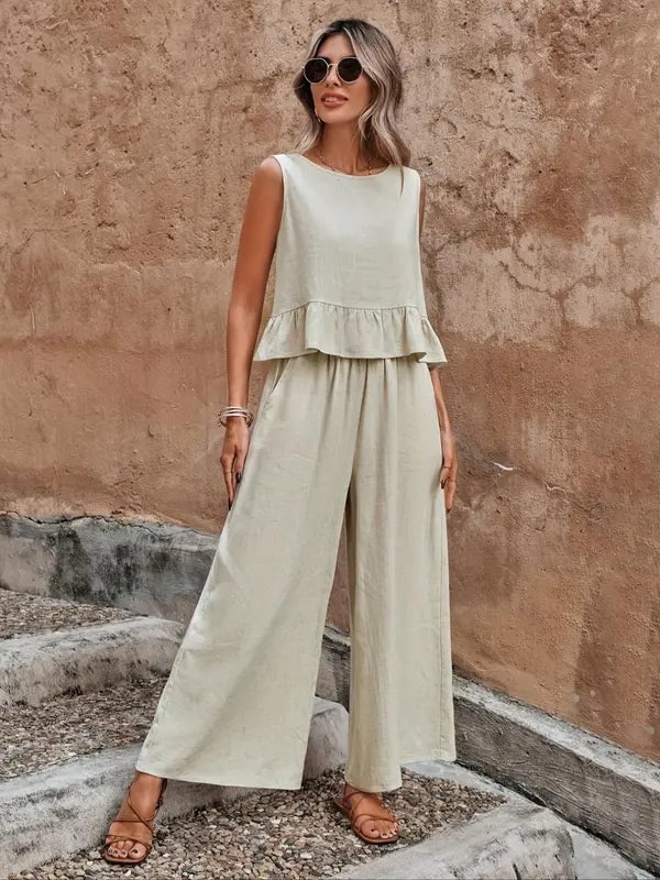 Woman wearing a khaki sleeveless ruffle-hem top and matching wide leg pants co-ord set, front view