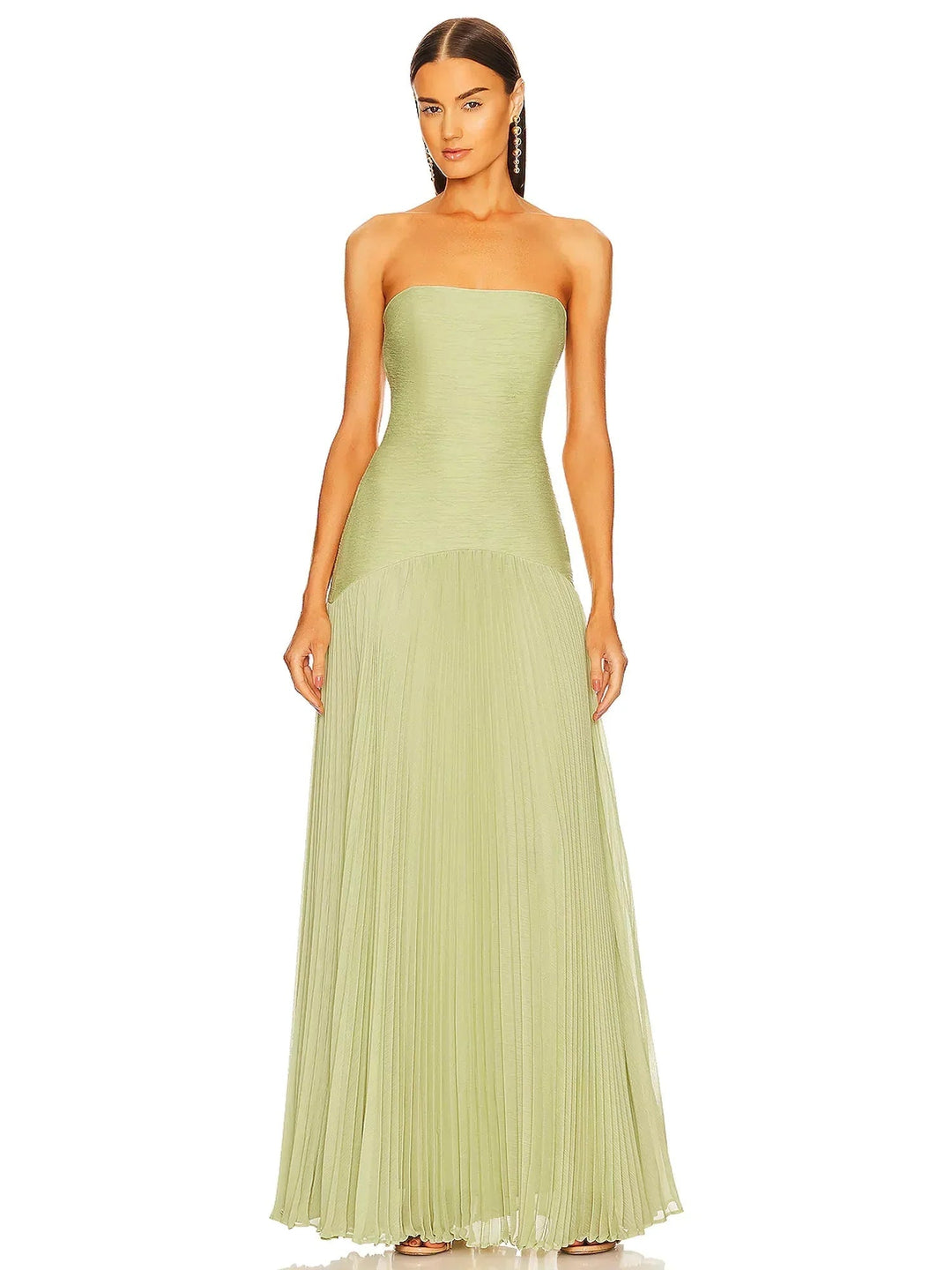 Woman wearing a sage green strapless pleated maxi formal gown with a dropped waist and floor-length skirt