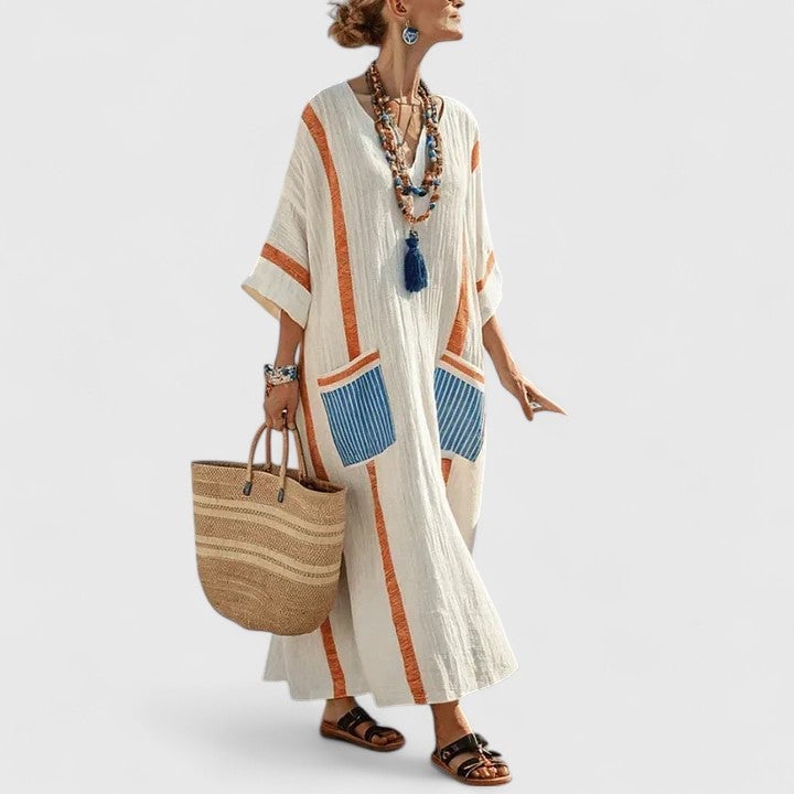Close-up of oversized patch pocket with teal trim detail on maxi dress