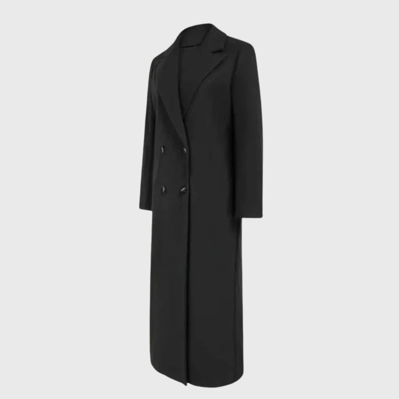 Model wearing a longline winter trench coat in black with an adjustable belt and buttoned cuffs