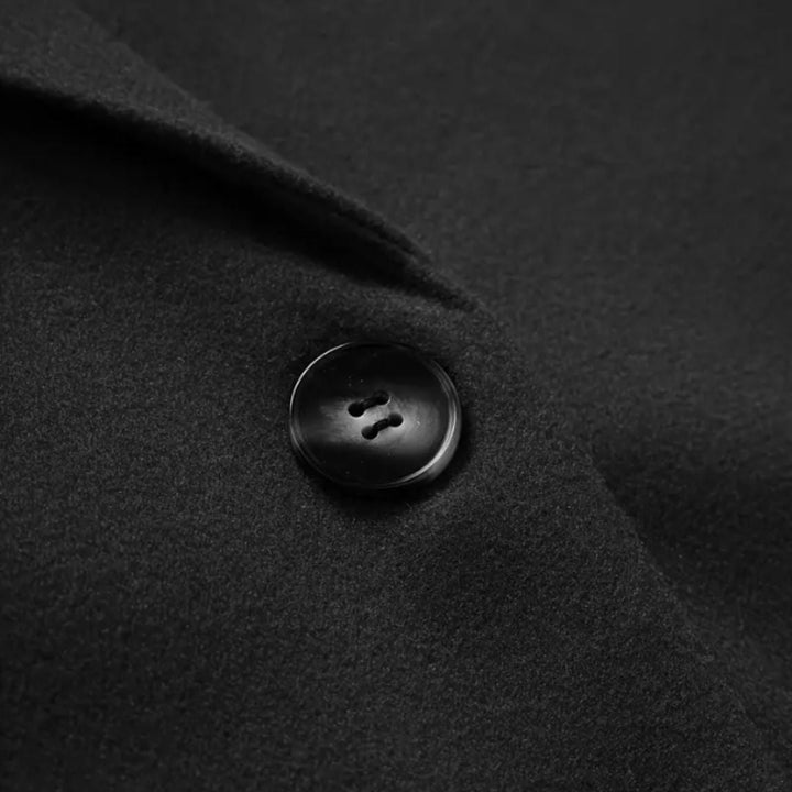Detail shot of buttoned cuffs on longline winter trench coat