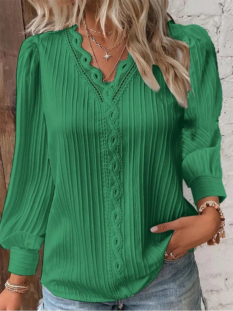 Side view of a chiffon blouse with puff sleeves in a relaxed fit worn by a woman
