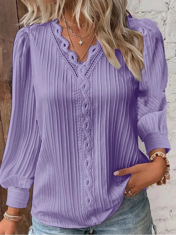 Woman styling a lilac chiffon lace blouse with high-waisted trousers