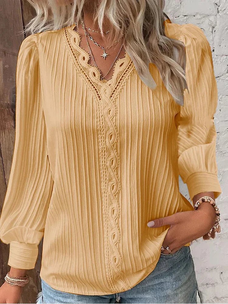 Detail shot of the puff sleeve and lace trim on a soft green chiffon blouse
