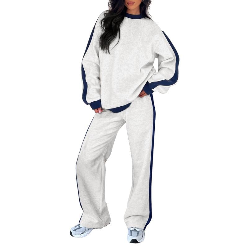 Woman wearing a matching white sweatshirt and pants lounge set with a relaxed, cozy fit