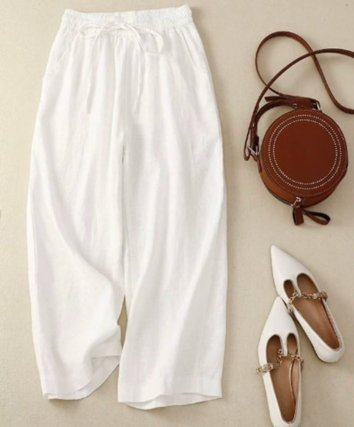 Close-up of the natural texture fabric and gathered waistband detail on the Sandra wide-leg pants