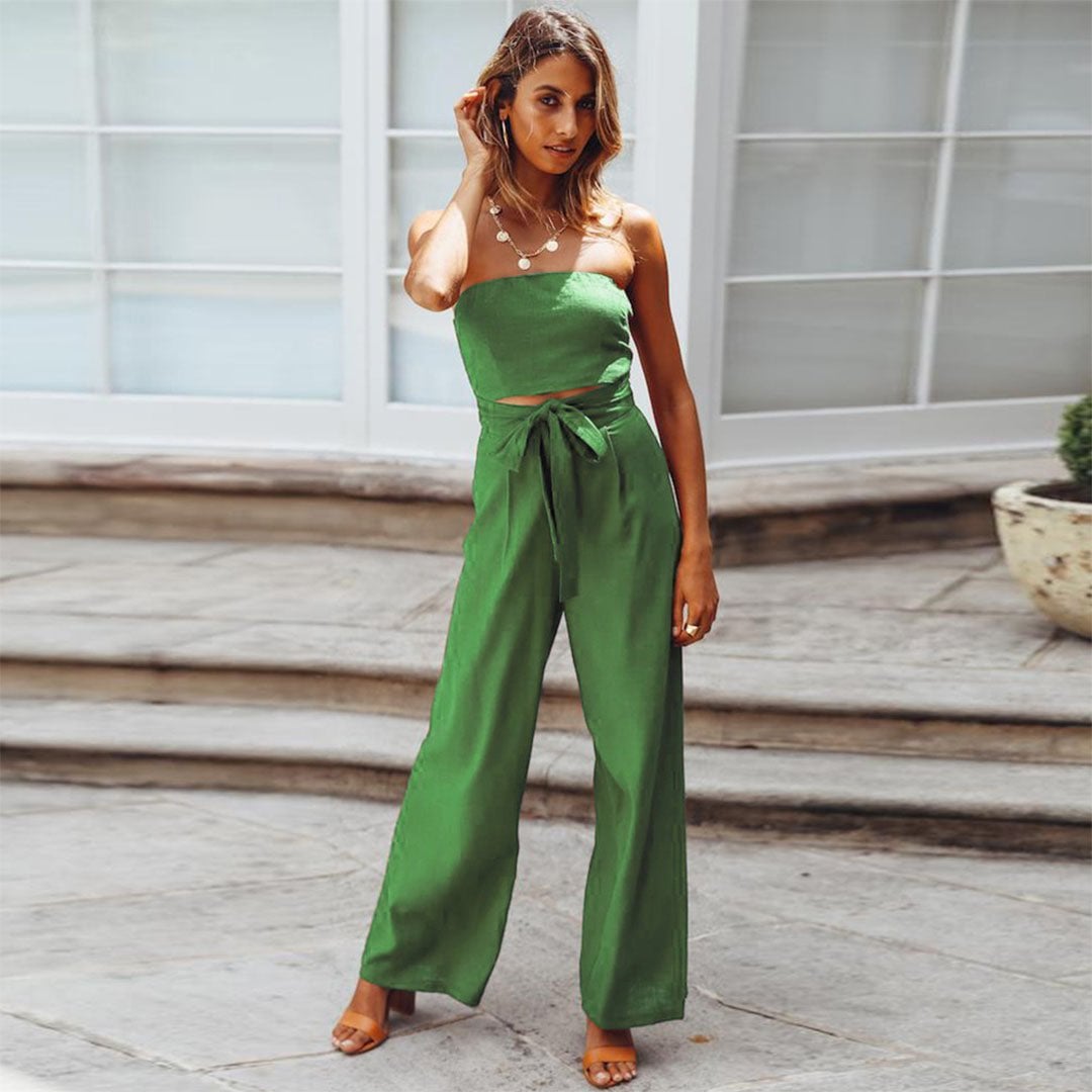 Front view of the Sandy strapless jumpsuit in beige showing the bandeau top and flowing wide-leg silhouette
