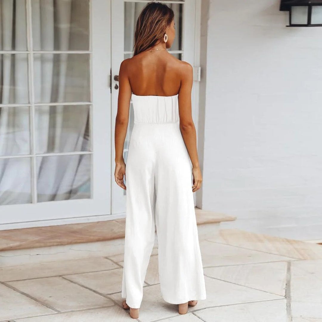 Woman wearing the Sandy jumpsuit in light blue at an outdoor setting