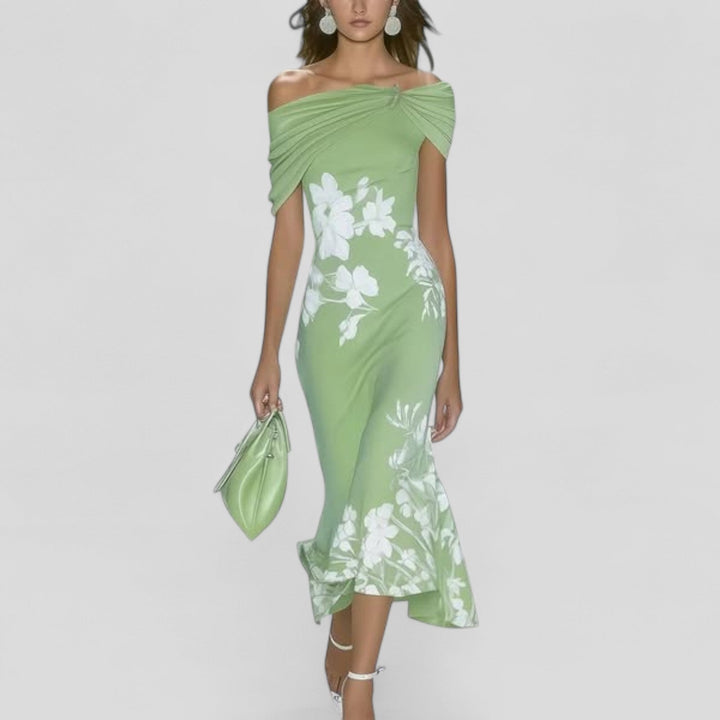 Woman wearing the Sania floral off-shoulder ruffle fishtail midi dress in sage green with white botanical print