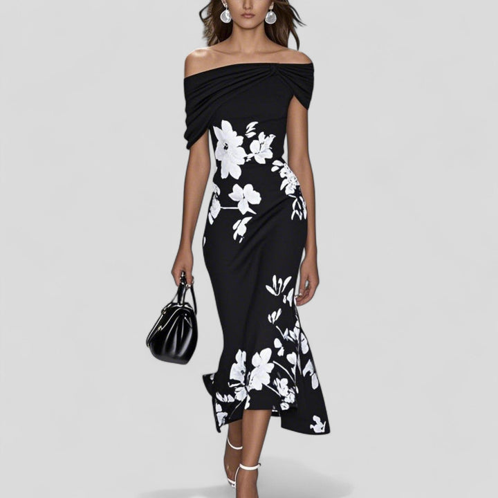 Close-up of the Sania dress ruffle fishtail hem detail showing flowy movement and floral print