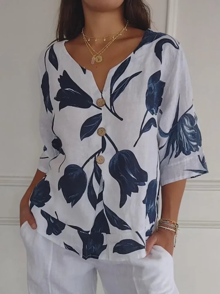 Woman wearing a floral button-up blouse with a relaxed fit in a soft white colorway