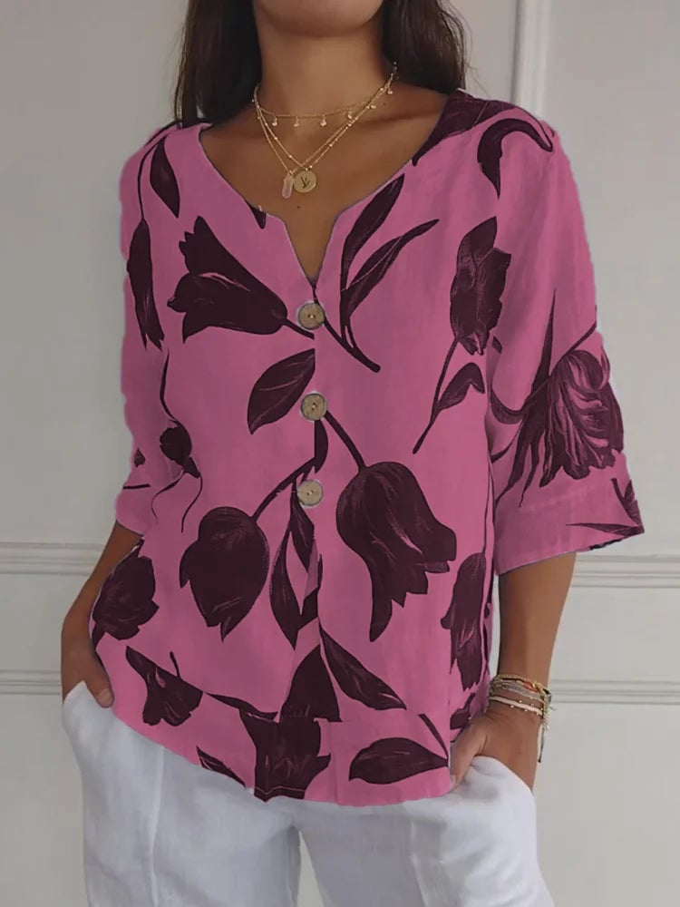 Close-up detail of the delicate floral print and full-length button closure on a feminine blouse