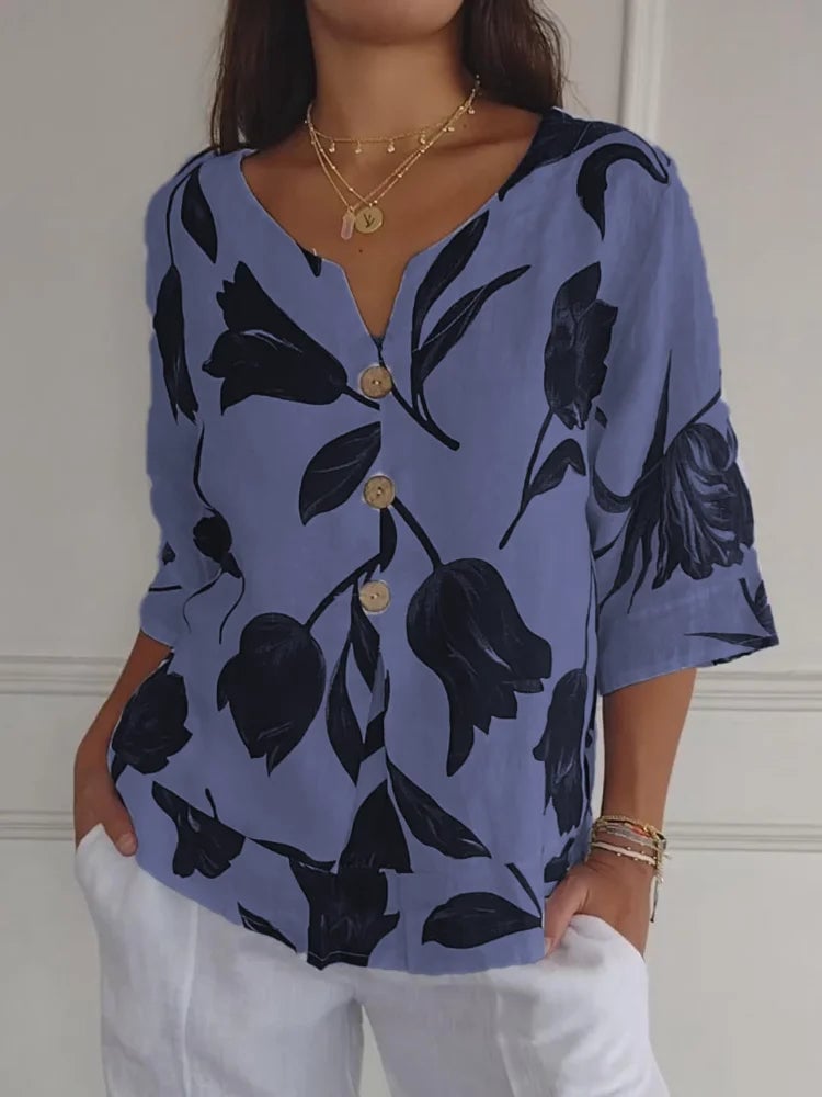 Model styled in a floral button-up blouse tucked into high-waisted denim for a casual daytime look