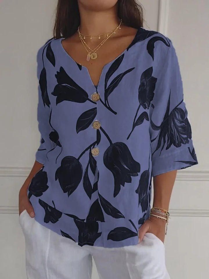 Model styled in a floral button-up blouse tucked into high-waisted denim for a casual daytime look