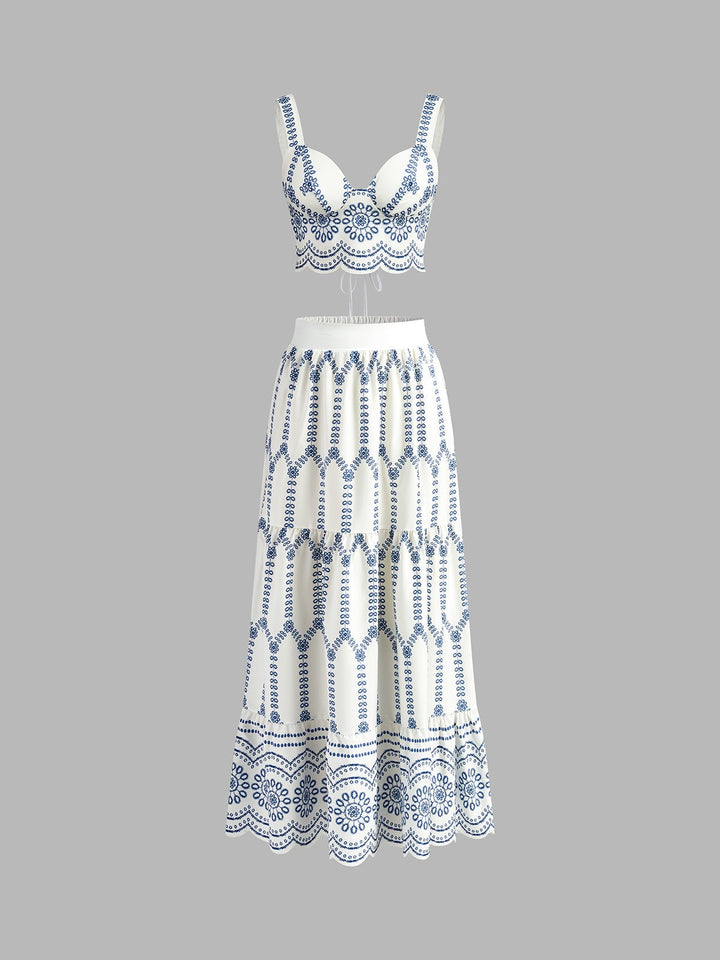 Front view of blue and white embroidered crop top and tiered maxi skirt co-ord set on a model