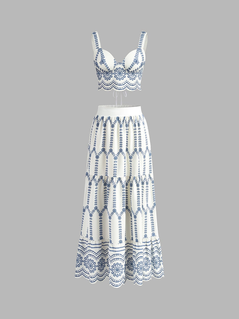 Front view of blue and white embroidered crop top and tiered maxi skirt co-ord set on a model