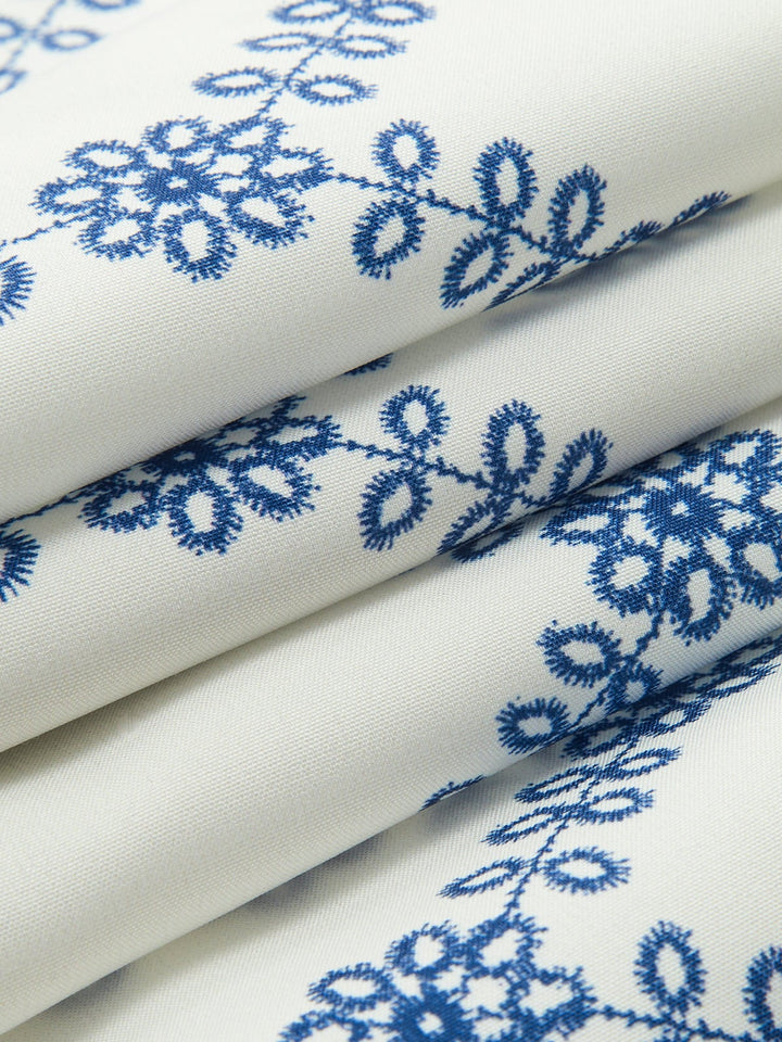 Flat lay of the embroidered crop top and maxi skirt co-ord set in blue and white