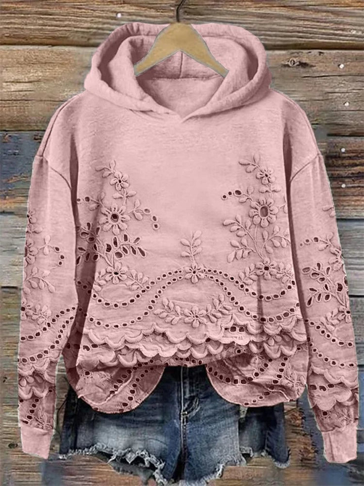 Woman wearing a relaxed-fit floral embroidered hoodie in a soft casual style