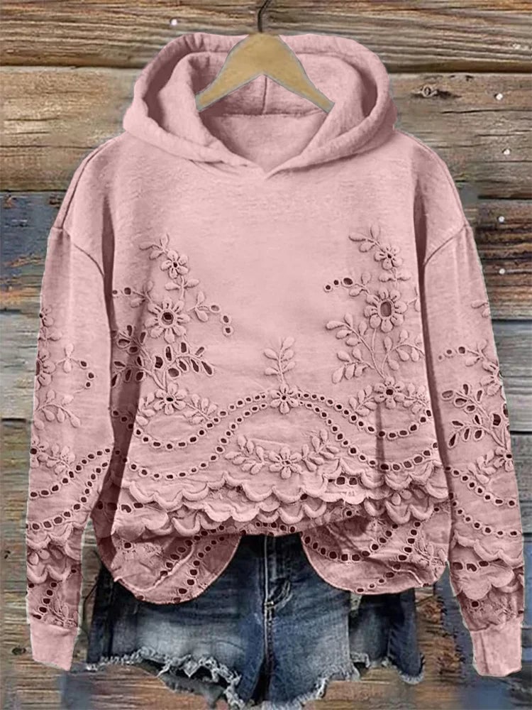 Woman wearing a relaxed-fit floral embroidered hoodie in a soft casual style