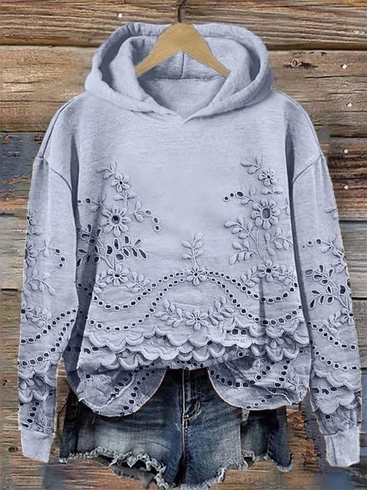 Close-up of delicate floral embroidery detail on a cozy women's hoodie