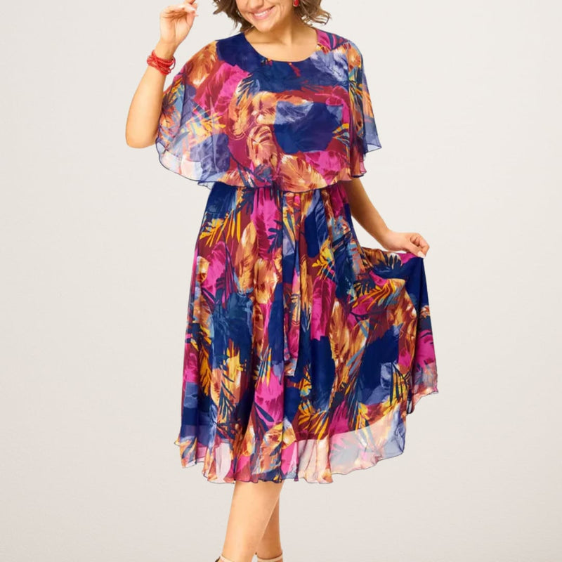 Woman wearing the Savannah flowy chiffon draped dress in a flattering tummy-control silhouette