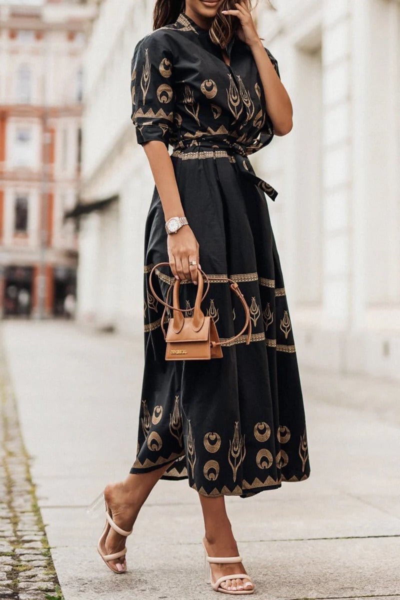 Woman wearing the Savannah boho print belted midi dress in black with geometric crescent motifs and a self-tie waist belt