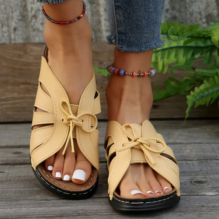 Scarlett women's sandals in dark blue, side view showing low profile sole