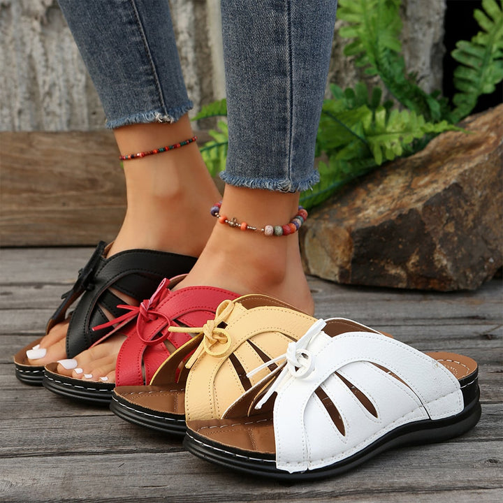 Close-up detail of Scarlett sandal cushioned sole and minimalist strap, multiple colors
