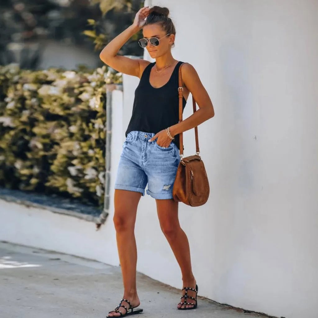 Back view of Scout high-waist light wash denim shorts showing patch pockets and rolled cuff hem detail