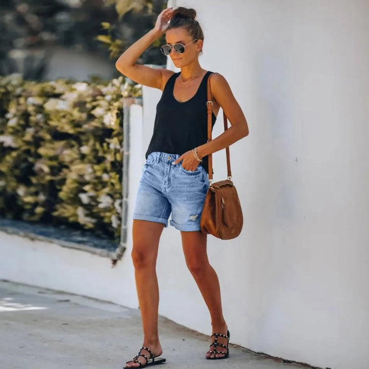 Back view of Scout high-waist light wash denim shorts showing patch pockets and rolled cuff hem detail